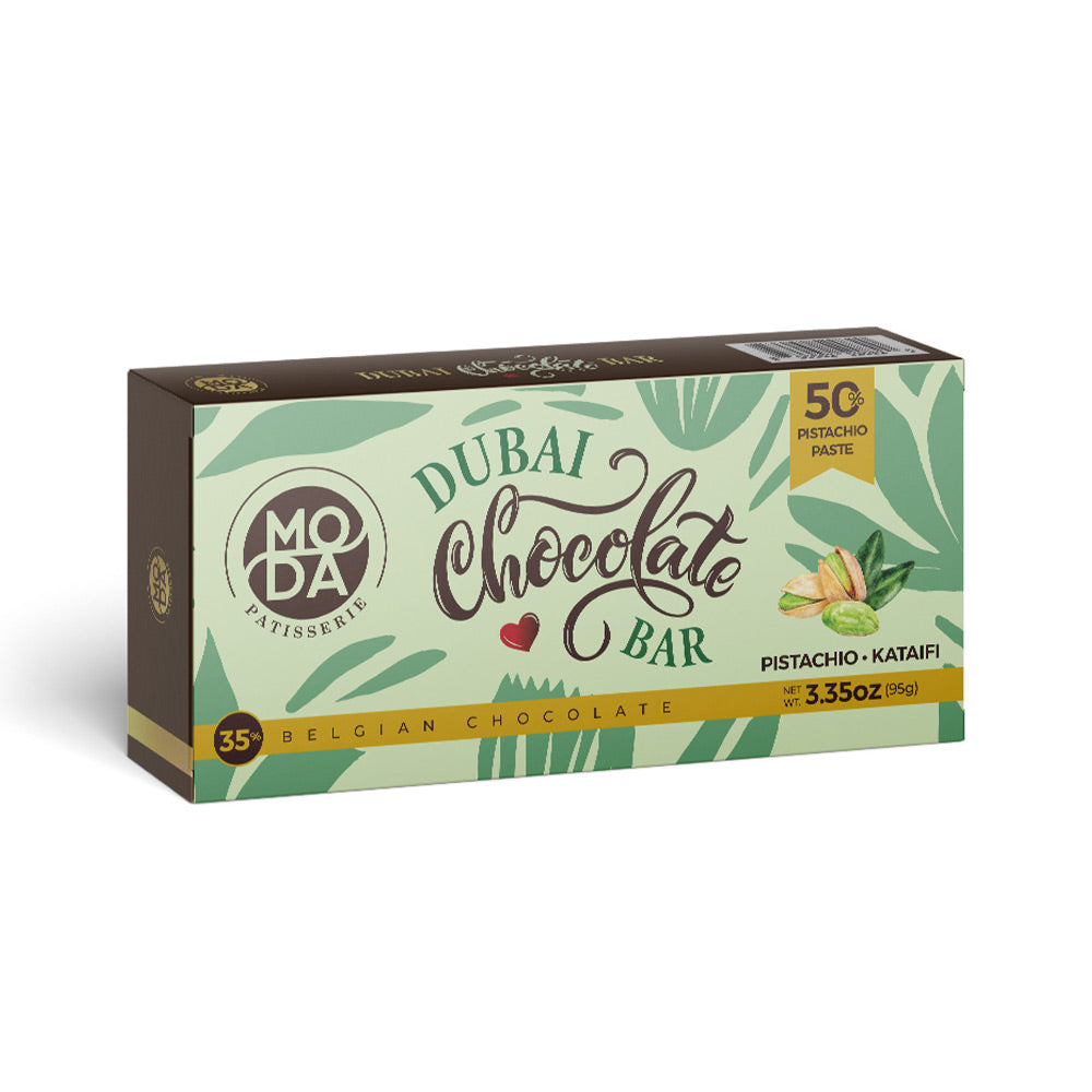 A box of Moda Patissierie Dubai Chocolate Bar, Pistachio - Katafi flavor, featuring a green and white tropical leaf pattern with brown and yellow accents.
