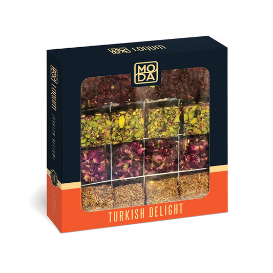 A boxed Turkish delight on a plain white background. The package is dark navy with an orange band at the bottom and a large clear window showing multiple tea blends arranged in a grid.