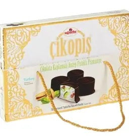 A box of Turkish chocolate with a gold and white ornate design, featuring a gold carrying handle, shown on a plain white background.