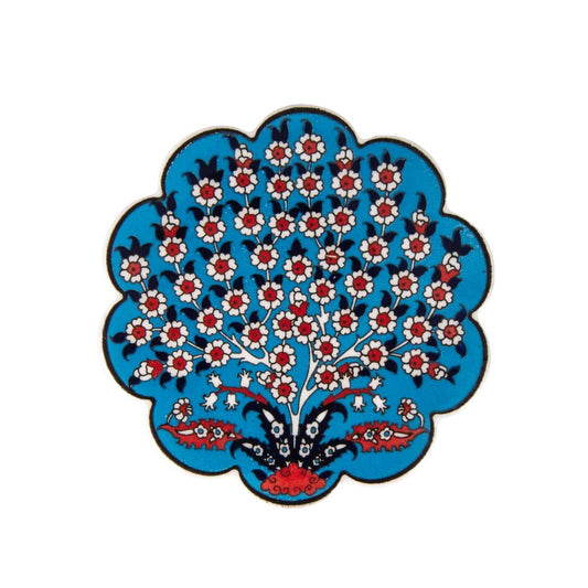 Blue scalloped ceramic tea coaster with white and red floral tree pattern